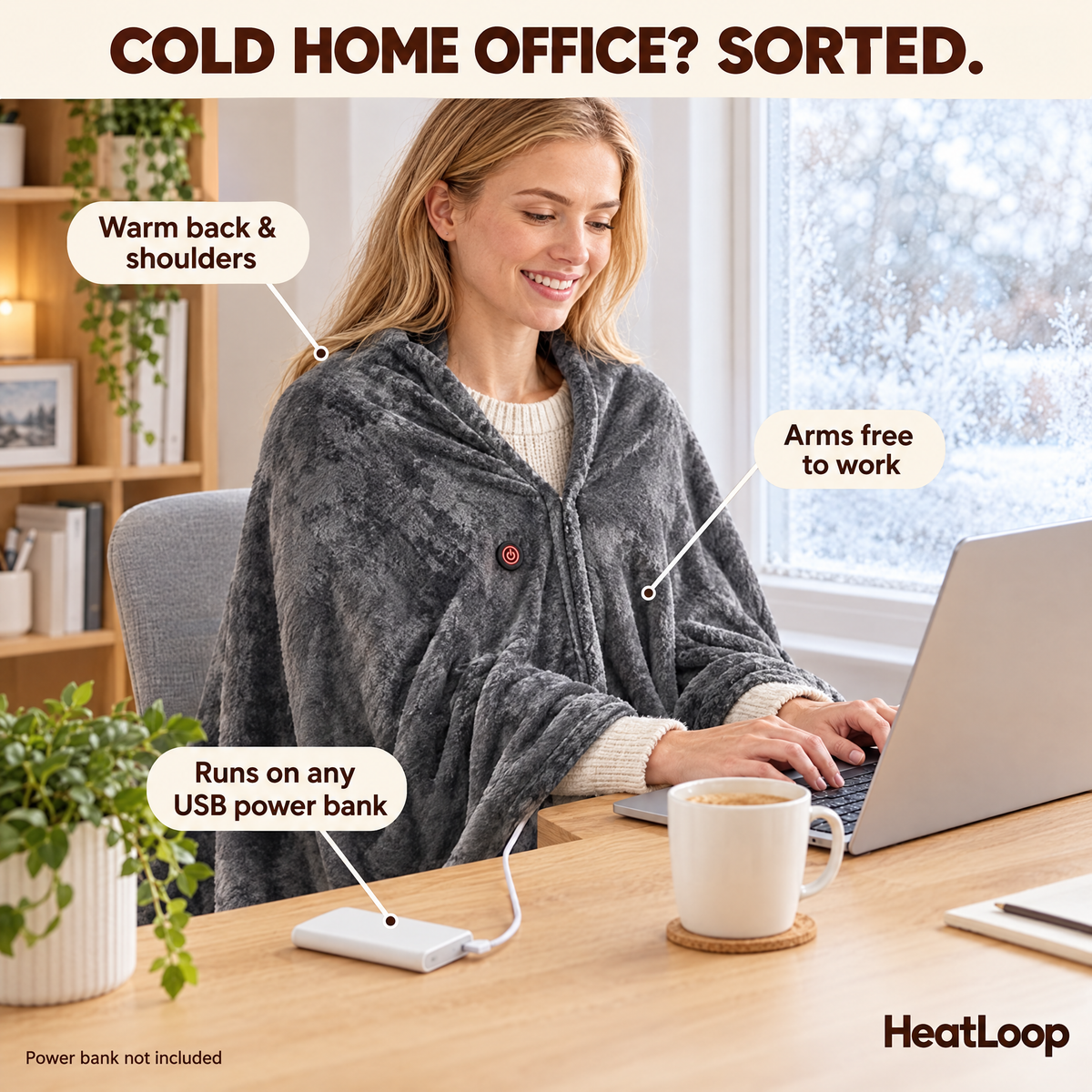 Woman working at a desk in the Grey HeatLoop heated wrap powered by a USB power bank